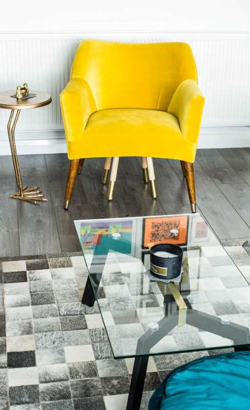 makeover will help you incorporate old furniture into a new home - a yellow chair with a glass table