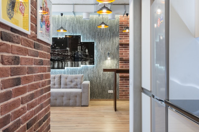 A living room with exposed brick walls