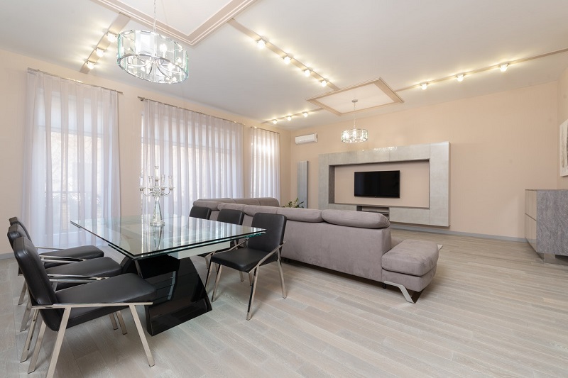 A living space with lots of natural light and lighting fixtures